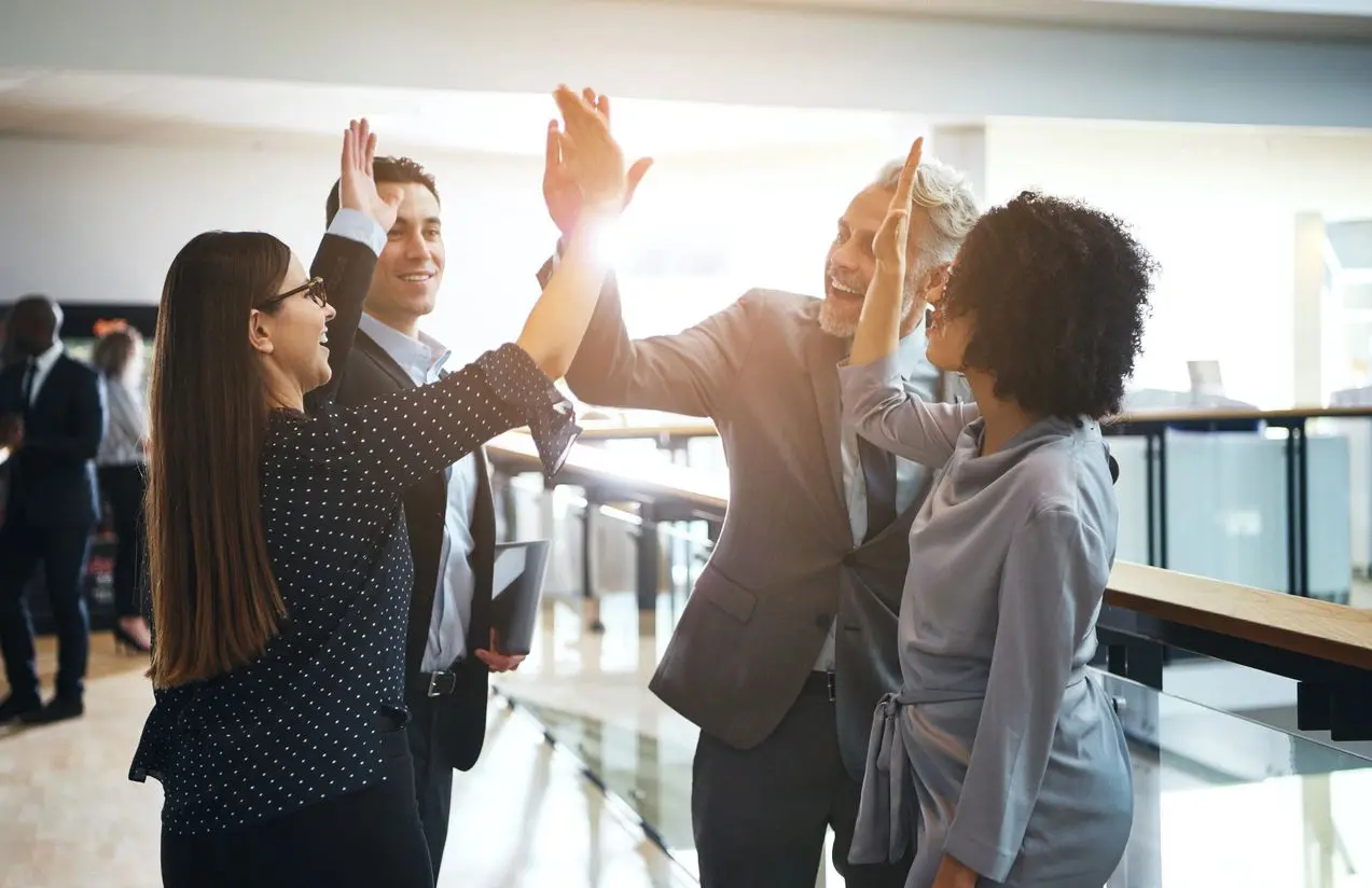 A group of people giving each other high fives.