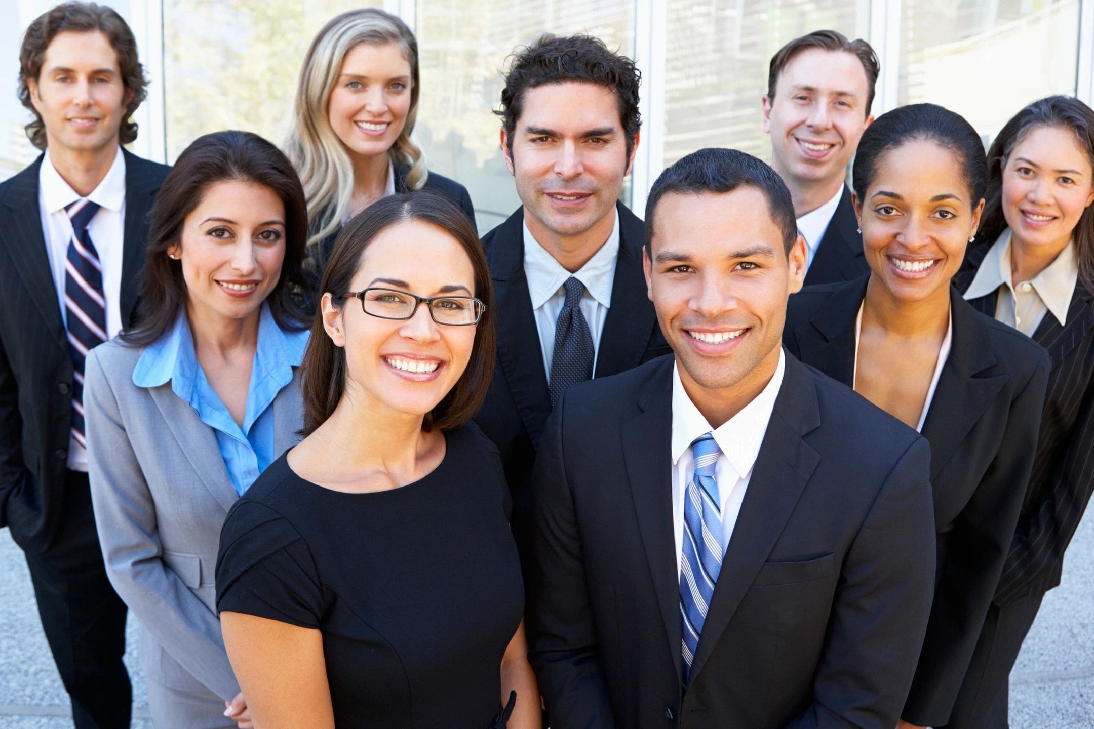 A group of people in business attire posing for the camera.